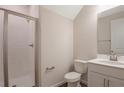 Clean bathroom with a glass-enclosed shower, white vanity, and modern fixtures at 565 Summit River Dr, Apopka, FL 32712