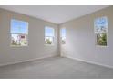 Bright bedroom with neutral carpet and plenty of natural light from three windows at 565 Summit River Dr, Apopka, FL 32712