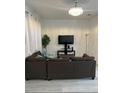 Spacious living room featuring a large television and comfortable seating arrangement at 615 Terra Lago St, Davenport, FL 33897