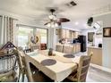Bright dining area featuring modern light fixtures and an adjacent kitchen at 624 Royal Palm Dr, Kissimmee, FL 34743