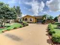 Charming home with a long driveway and lush landscaping at 624 Royal Palm Dr, Kissimmee, FL 34743