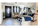 Cozy living room with neutral tones, wood flooring and decorative accents at 624 Royal Palm Dr, Kissimmee, FL 34743