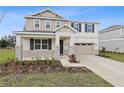 Inviting two-story home featuring a landscaped front yard and a spacious two-car garage at 630 Summit River Dr, Apopka, FL 32712