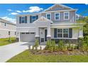Attractive two-story home featuring a well-maintained lawn and complementary gray color palette at 645 Summit River Dr, Apopka, FL 32712