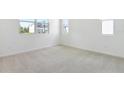 Bright, carpeted bedroom with ample natural light from windows, showcasing a calm, neutral space at 655 Summit River Dr, Apopka, FL 32712