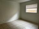 Bedroom with tiled floors and natural light coming through the window at 731 Michigan Ct # 1, St Cloud, FL 34769