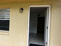 Close up of the unit entrance, showcasing the door and exterior lighting fixture at 731 Michigan Ct # 1, St Cloud, FL 34769