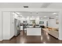 Modern kitchen with white cabinets, a black countertop island, and stainless steel appliances at 736 Forest Glen Ct, Maitland, FL 32751