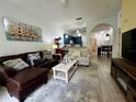 Cozy living room area leading to a dining and kitchen area with stainless steel appliances at 1106 Gran Bahama Blvd # 1106, Davenport, FL 33897