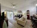 Bright living room features wood-look floors, sliding glass doors, and modern decor at 1106 Gran Bahama Blvd # 1106, Davenport, FL 33897