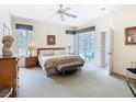 Spacious main bedroom with soft carpet, neutral walls, and a private access door to the pool at 116 Westport Ln, Davenport, FL 33896