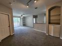 Spacious living room with carpet, ceiling fan, a balcony, and built in shelves at 1325 Lake Shadow Cir # 12205, Maitland, FL 32751