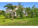 Lush backyard with mature trees and landscaping surrounding the house, providing plenty of privacy at 16072 Shasta St, Clermont, FL 34714
