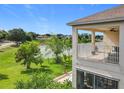 Relaxing balcony with a ceiling fan overlooking the peaceful lake, providing a great view at 16072 Shasta St, Clermont, FL 34714