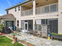 Spacious patio with chairs, an outdoor kitchen area, and a chicken coop, perfect for outdoor living at 16072 Shasta St, Clermont, FL 34714