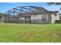 Backyard with a screened-in patio over a pool, perfect for outdoor entertaining and relaxation at 163 Kenny Blvd, Haines City, FL 33844