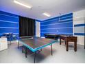 Bright game room with a foosball table, ping pong table, and modern bar-style seating for entertainment at 1810 Caribbean View Ter, Kissimmee, FL 34747