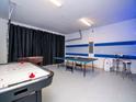 Spacious game room featuring an air hockey table, ping pong table, and foosball table at 1810 Caribbean View Ter, Kissimmee, FL 34747