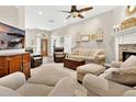 Spacious living room with fireplace, wood floors, and lots of comfy seating perfect for entertaining friends and Gathering at 1822 Ashton E Dr, St Cloud, FL 34771