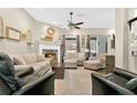 Beautifully decorated living room featuring wood floors, a fireplace and large windows, making it a warm and inviting space at 1822 Ashton E Dr, St Cloud, FL 34771