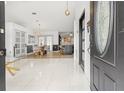 Bright foyer with marble floors, pendant lighting, and an open view into the dining and kitchen areas at 1913 Manatee Ct, Kissimmee, FL 34759