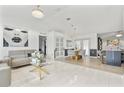 Open-concept living room with marble floors, modern lighting, and stylish furnishings at 1913 Manatee Ct, Kissimmee, FL 34759