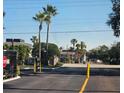 Gated entrance to community with lush tropical landscaping and well-maintained grounds at 1920 Conway Rd # 4, Orlando, FL 32812