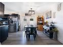 The dining area showcases an elegant light fixture, complemented by stainless steel appliances in the adjacent kitchen at 2 S Lavon Ave, Kissimmee, FL 34741