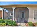 The home has a screened-in front porch entry with brick pavers and an ornamental metal door at 214 Verona Dr, Kissimmee, FL 34759