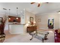 A spacious living area that opens to the kitchen featuring tile floors and contemporary furnishings at 214 Verona Dr, Kissimmee, FL 34759