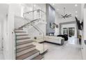 Bright, open living space featuring a cozy fireplace and modern staircase at 2561 Montego Bay Blvd, Kissimmee, FL 34746