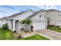 Inviting single-story home with landscaped front yard and two-car garage at 2838 Common Crane Ct, Harmony, FL 34773