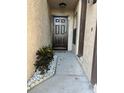 Inviting front entrance with walkway, decorative stone, and lush plants at 2900 S Semoran Blvd # 1, Orlando, FL 32822