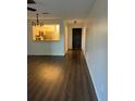 Open-concept living room featuring sleek laminate flooring at 2900 S Semoran Blvd # 1, Orlando, FL 32822