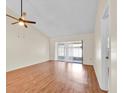 Open living room with vaulted ceiling, ceiling fan and sliding glass doors to the exterior at 2907 Prince Oak Ct, St Cloud, FL 34769