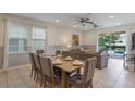 Cozy dining and living area with ample natural light and sliding glass doors opening to the outdoor pool at 331 Pendant Ct, Kissimmee, FL 34747