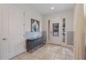 Bright entryway featuring a tiled floor, decorative mirror, and ample natural light at 331 Pendant Ct, Kissimmee, FL 34747
