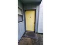 Exterior shot of a yellow front door with a small window to the side of it at 4341 Aqua Vista Dr # A, Orlando, FL 32839