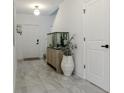 Inviting entryway featuring tile flooring, an aquarium, and crisp, white trim at 466 Cool Summer Ln, Davenport, FL 33837