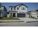 Charming two-story home featuring a two-car garage, stylish shutters, and manicured landscaping at 466 Cool Summer Ln, Davenport, FL 33837