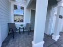 Inviting front porch with cozy seating, perfect for enjoying a relaxing afternoon at 4736 Tribute Trl, Kissimmee, FL 34746