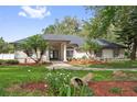 Attractive one story home with a landscaped yard, healthy lawn, mature trees and decorative urn in the front yard at 5254 Mill Stream Dr, St Cloud, FL 34771