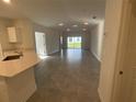 Bright, open-concept living room and kitchen area with recessed lighting and sliding glass doors to the outside at 553 Sea Turtle Ln, Haines City, FL 33844