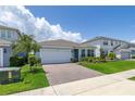 Attractive home with a brick driveway, green lawn, and mature landscaping at 5648 Cedar Chase Dr, St Cloud, FL 34771