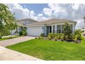 Beautiful home featuring a brick driveway, lush lawn, and manicured landscaping at 5648 Cedar Chase Dr, St Cloud, FL 34771