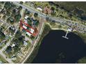 Aerial view of property with lake view, and surrounding neighborhood, outlined in red at 612 Lakeshore Blvd, Kissimmee, FL 34744