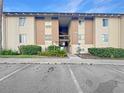 Exterior shot of building with covered stairwells and assigned parking at 626 Orange Dr # 243, Altamonte Springs, FL 32701
