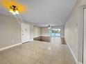 Spacious living room with tiled flooring and sliding glass doors leading to balcony at 626 Orange Dr # 243, Altamonte Springs, FL 32701