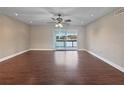 Open-concept living room with hardwood flooring, fan and view of the lake at 626 Orange Dr # 243, Altamonte Springs, FL 32701