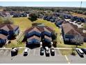 Aerial view of community featuring well-manicured lawns, a pond, and ample parking at 658 Caribbean Dr, Davenport, FL 33897